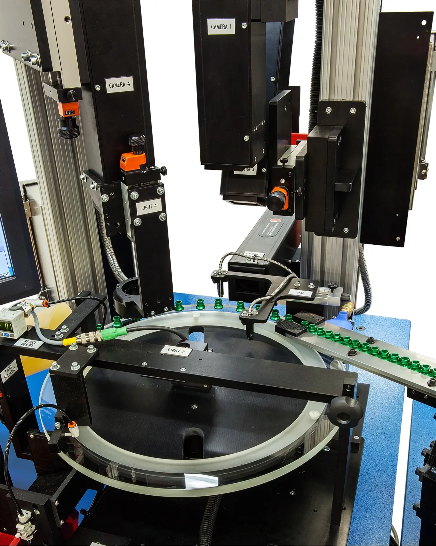 Close-up of an automated inspection machine showing labeled cameras and lights positioned around a rotary indexing table.